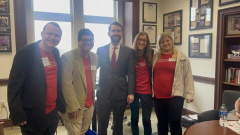 Four students meet with Rep. Houston Gaines during IPSE Advocacy Day at the State Capitol.